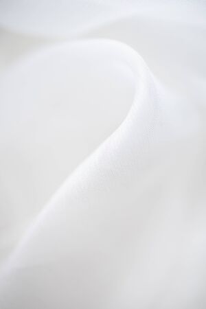 Close up of white linen cloth . Texture and fabric background or wallpaper.