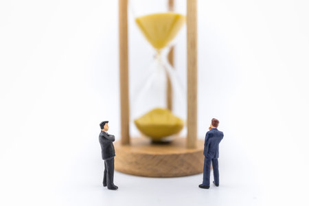Business, Workin, Time and Management concept. Close up of two businessman miniature figure standing...