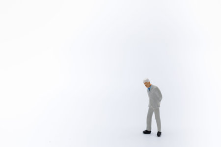 Close up of business,am miniature figure standing and walking on white background with copy space for text.の写真素材