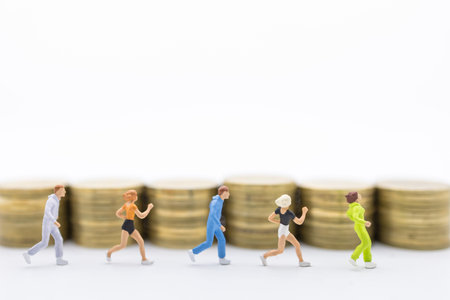 Business, Money and sport concept. Close up of group runner miniature figure people running in front...