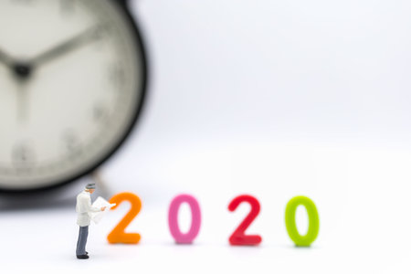 Business and 2020 New Year Planning Concpet. Close up of businessman miniature figure people...