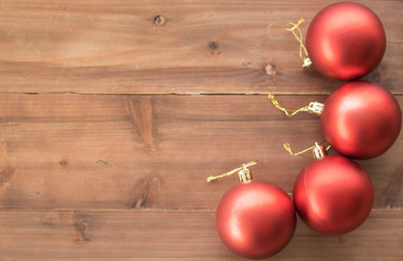 Happy New Year and Christmas Concept. Flat lay view of red ornament ball on old wooden plank with...
