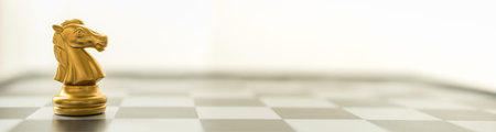 Sport board game, Business and Planning Cover Concept. Closeup of knight chess piece on chessboard...