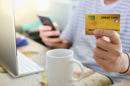 E-Commerce, Shopping and work from home Concept. Man hand holding and present show credit card and...