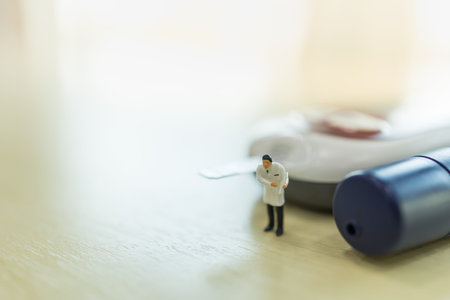 Medicine, diabetes, glycemia, health care and people concept - close up of doctor miniature figure...
