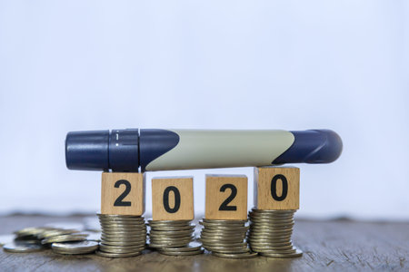 2020 and Medicine, diabetes, glycemia, health care and Money concept - close up of lancet for check...