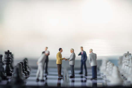 Business, Teamwork Concept. Group of businessman miniature figure people meeting on chessboard with chess pieces.の写真素材