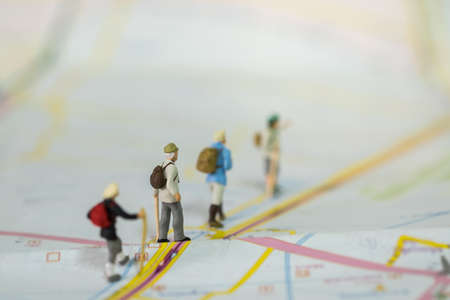 Travel and Journey Concept. Group of traveler miniature figure people with backpack walking on map with copy space.の写真素材
