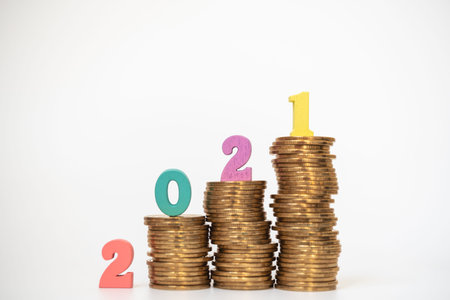 2021 Money, Business and planning Concept. Colorful wooden number letter on unstable stack of gold...