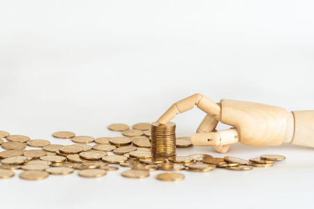 Business Money and Saving Concept. Closeup of wooden hand model finger point to top of stack of gold...