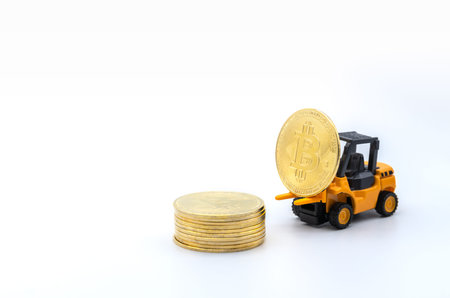Business , Money, Technology and  cryptocurrency Concept. Closeup of gold bitcoin coin on forklift...