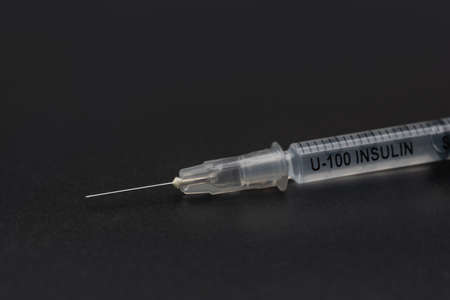 Closeup U-100 Insulin syringe on blackの写真素材