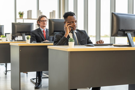 Diversity Business and Work palce concept. African businessman talking on call with mobile...