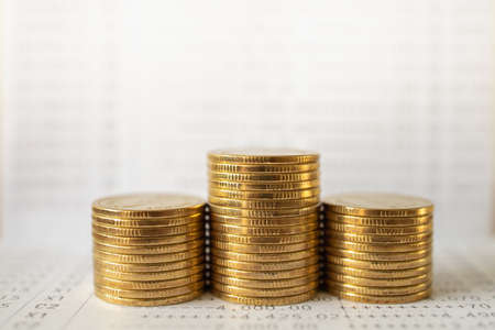 Business Money and Financial Concept. Closeup of stack of gold coins on bank passbook.の写真素材