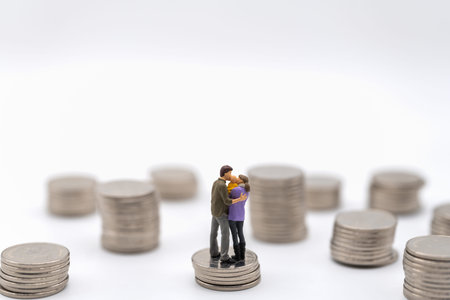 Money, Financial, Business and Family concept. Parent man, woman and kid Miniature figures hug and...