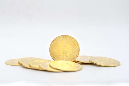 Business , Money, Technology and  cryptocurrency Concept. Closeup of gold bitcoin coin with pile of coins isolated on white background.の写真素材