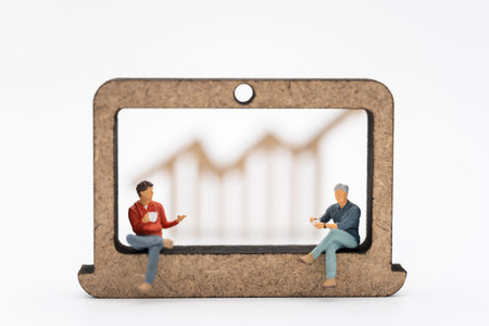 Business Technology and Financial Concept. Two businessman miniature figure people with cup of...