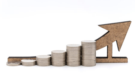 Business Money,  Planning and Growth Concept. Closeup of stack of silver coins with wooden arrow on white background.の写真素材