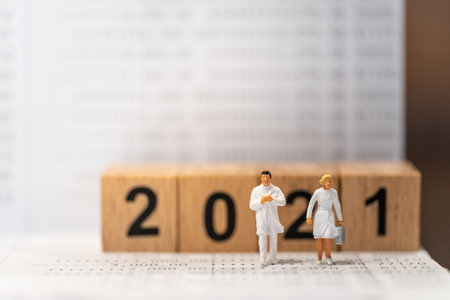 2021 New year Business, Money planning and Healthcare concept. Doctor and nurse miniature figure...