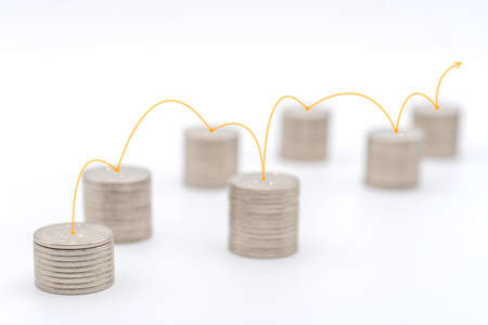 Business Money and Planning Concept. Closeup of stack of silver coins with red line to connect each stack on white background.の写真素材