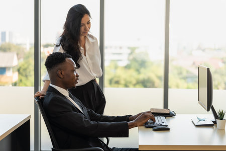 Diversity Business and Team Work concept. African businessman and businesswoman team colleague working  with desktop computer in office.の写真素材