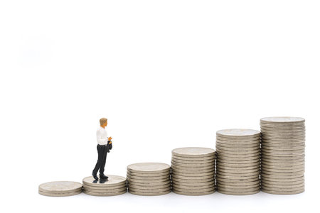 Business, Money Investment and Planning Concept. Businessman miniature figure people figure walking on stack of silver coins on white background.の写真素材