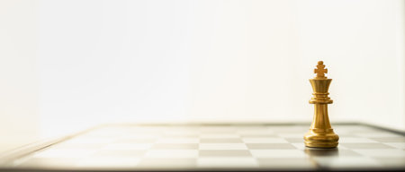 Business, Game and Planning Cover Page Concept. Closeup of king and gold chess pieces on cheseboard with copy space.の写真素材