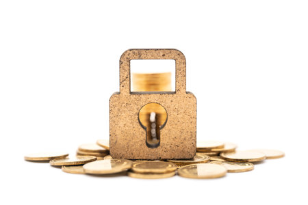 Money and Security Concept. Closeup of  wooden master key lock icon with pile and stack of gold...