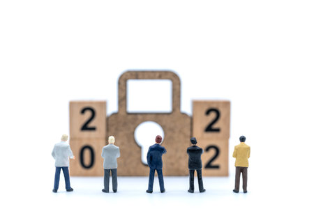 2022 New Year and Business Planning Concept. Closeup of group of businessman miniature figures...