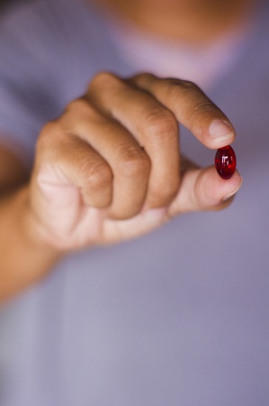 a red tablet is handed out by a woman.の写真素材