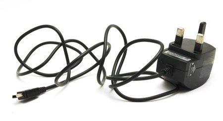 a travel charger for electrical devices, isolated on white.の写真素材