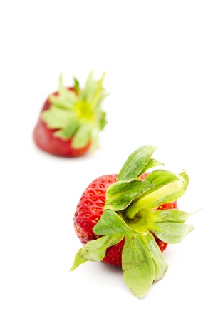 single isolated strawberry with other strawberries in the background.の写真素材