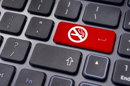 a no smoking sign on keyboard enter key, to convey anti smoking concepts in workplaces or offices.の写真素材