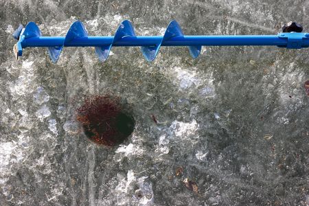 hand ice auger on the iceの写真素材