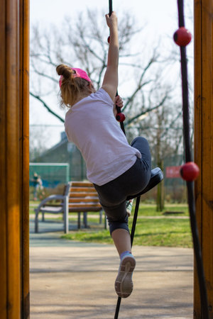 girl is climbing in the playground