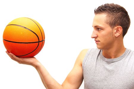 a basketball player holds the ball in front of his faceの写真素材