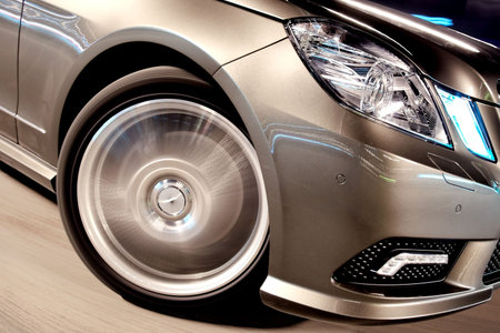 Front wheel closeup of a speeding car