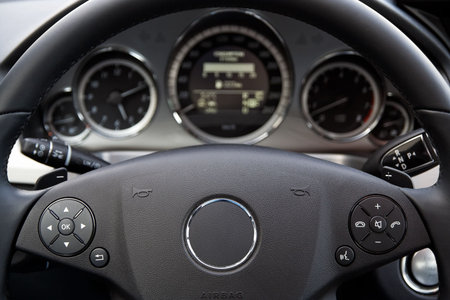 Modern car dashboard. Focus on steering wheel.