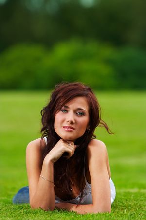 Young teenage girl lying on a grassの写真素材
