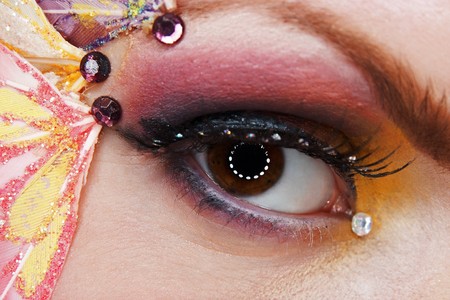 Creative fantasy eye makeup with pink and yellow eyeshadow  macro shotの写真素材
