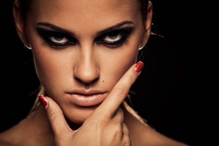 Closeup portrait of a serious lady with smoky eye makeupの写真素材