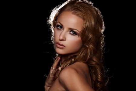 Closeup portrait of a beautiful lady on blackの写真素材