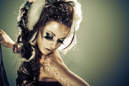 Vogue style portrait of a woman with gold-silver bodyart and makeupの写真素材