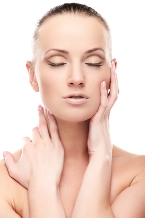 Portrait of beautiful female model with closed eyes on white backgroundの写真素材