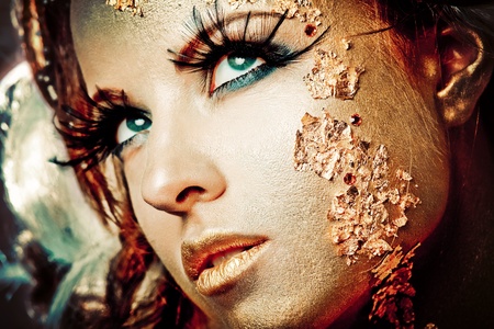 Vogue style portrait of a woman with gold makeupの写真素材