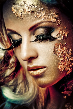 Vogue style portrait of a woman with gold makeupの写真素材