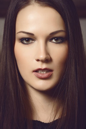 Closeup portrait of a beautiful brunette lady. Cross process toning.の写真素材