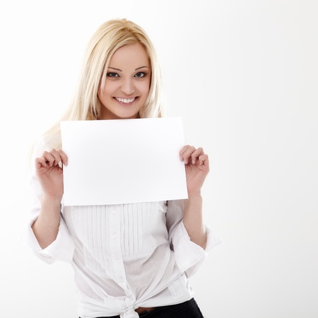 Smiling young businesswoman holding a blank A4 paperの写真素材