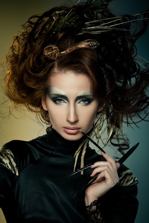 High fashion model in black dress, with long nails and creative hairstylingの写真素材
