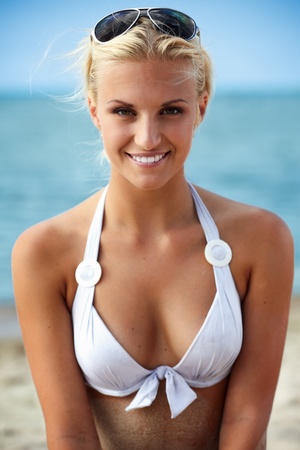 Sexy blond girl posing on a beachの写真素材